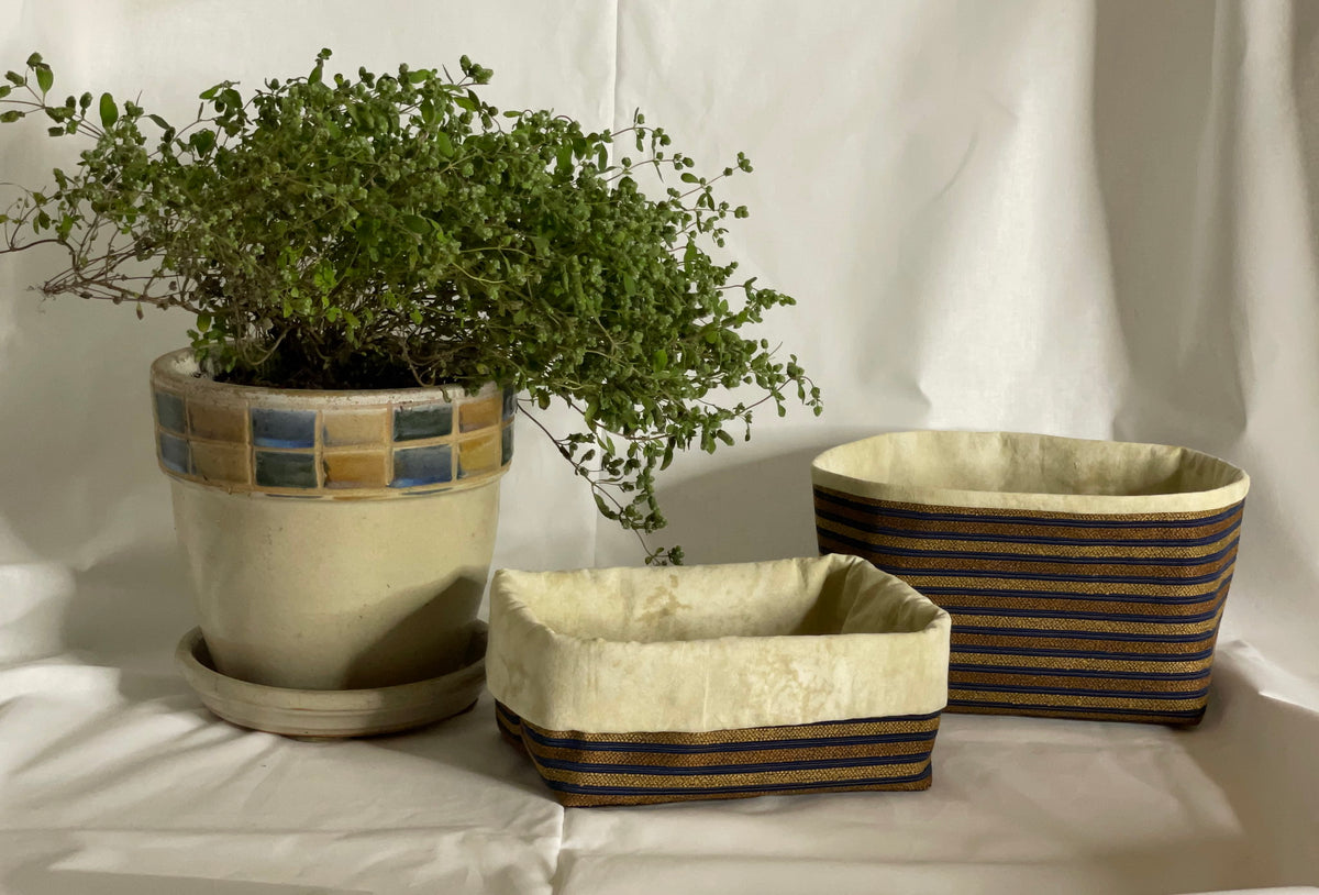 Deux paniers tissu texturé couleurs riches lignés bronze, doré et intérieur chamoiré beige pâle.